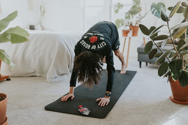 Person exercising at home, showing how to stay fit without going to the gym