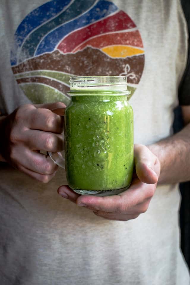 Person holding healthy smoothy to promote gut health